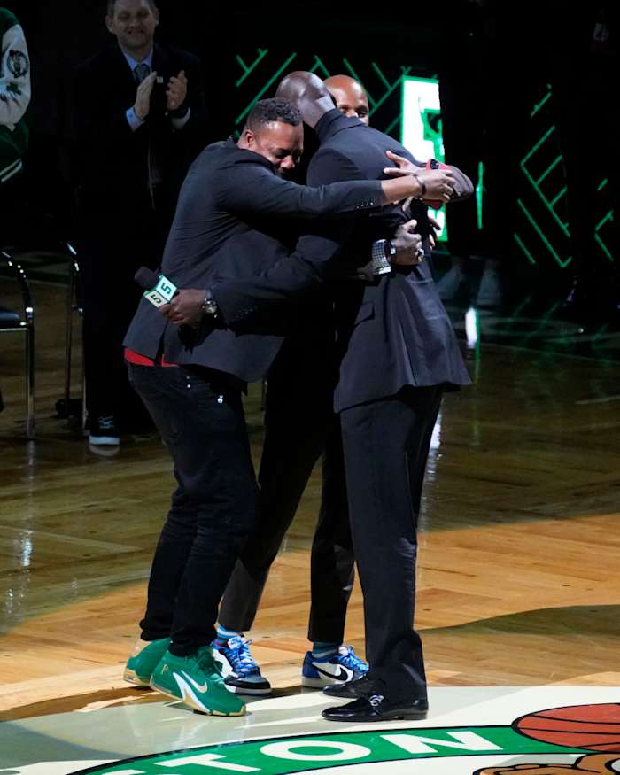 Basketball Hall of Famer and former Boston Celtic, Kevin Garnett embraces former Boston Celtics players, Ray Allan and Paul Pierce during the number retirement ceremony after the game between the Boston Celtics the Dallas Mavericks at TD Garden.